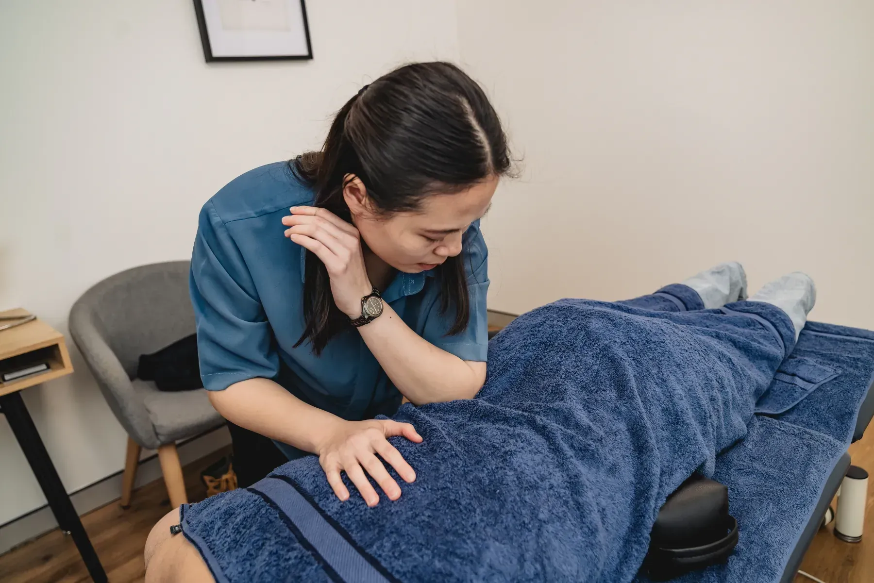Chiropractor Gianna Lau providing hands-on treatment to a patient at the Chatswood clinic